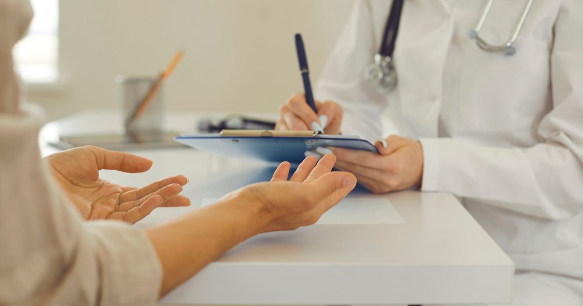 Doctor consulting with a patient in a medical setting.